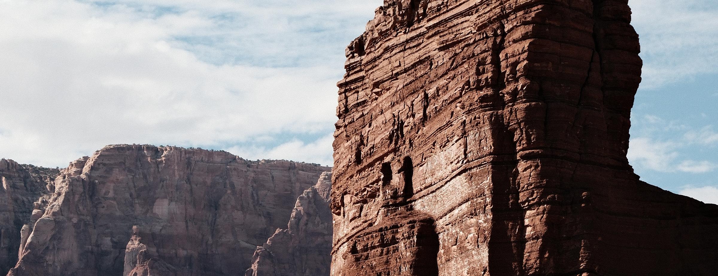 Red sandstone butte and canyon walls under a cloudy sky in northern Arizona