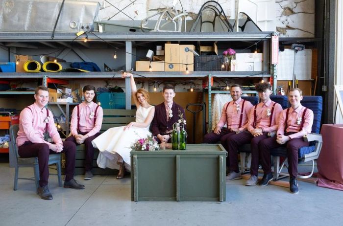 Wedding party seated in an aircraft hangar