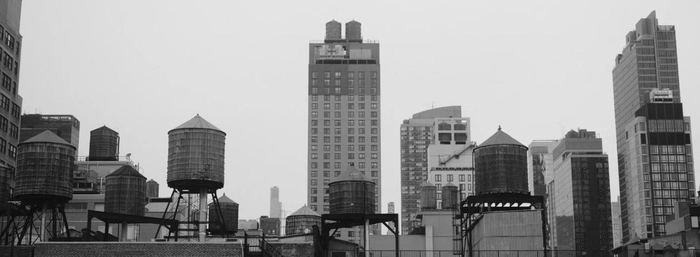 Rooftop water towers against the New York skyline, black and white