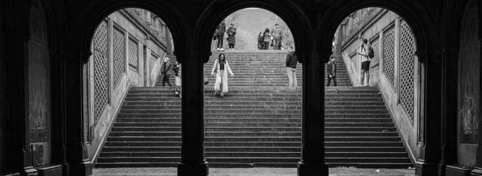 People on the stairs beneath the arches of Bethesda Terrace